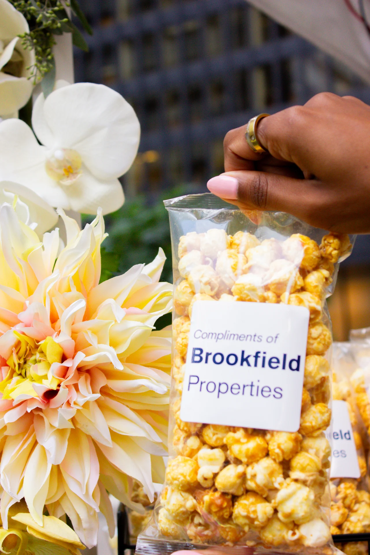 A fully branded Luv Pop popcorn station built for a corporate activation - cart, bags, and signage styled to the client